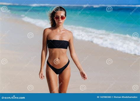 Beautiful European Girl In Black Bikini And Sunglasses On Tropical