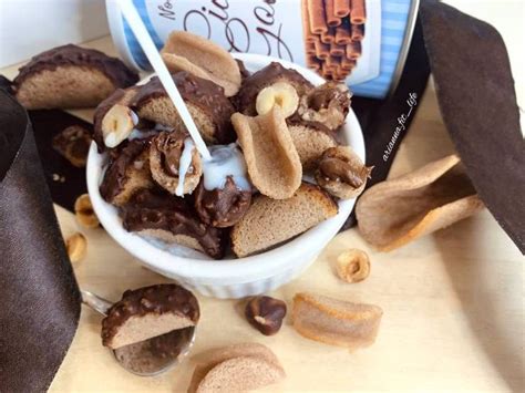 A Bowl Filled With Nuts Next To A Bag Of Milk