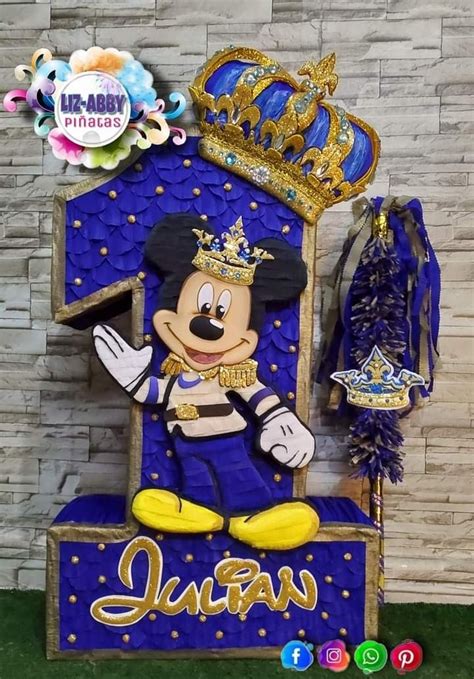 A Mickey Mouse Statue With A Crown On It S Head And Some Decorations