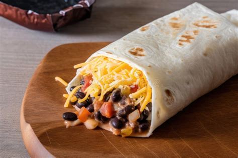 Cheesy Burrito Wrap With Shredded Cheese Black Beans And Salsa Stock