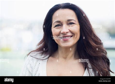 Portrait Of Smiling Mature Woman Standing Outdoors Stock Photo Alamy