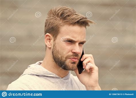 Man With Beard Walks With Smartphone Urban Background With Stairs Man