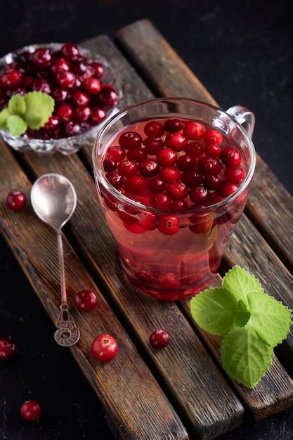 Premium Photo Cranberry Juice With Honey In A Cup Cranberries In