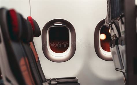 Airplane window and seats stock image. Image of bokeh - 156387827