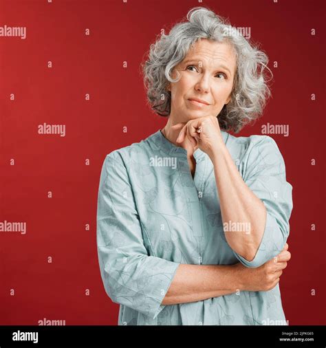 Mature Woman Thinking Making A Decision Or Choice About What To Wear