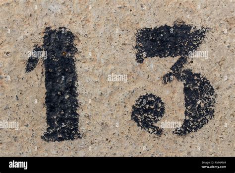 number thirteen painted stencil on concrete wall, number 13 Stock Photo ...