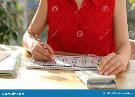 Woman Marking Date In Calendar With Drawing Pin Royalty Free Stock