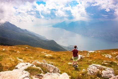 Premium Photo Hiker Looking At Panoramic View Of Lake Garda From A