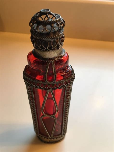 Vintage Red Perfume Bottle With Metal Scroll Work Overlay And Matching