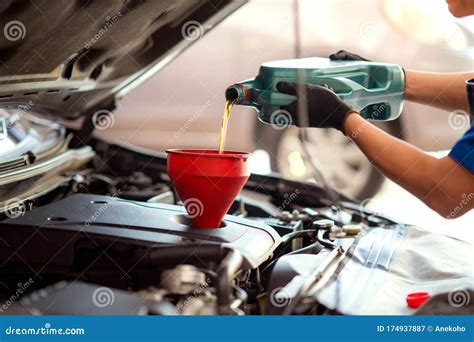 Pouring Oil To Car Engine Mechanic Pouring Oil Into Car Stock Image