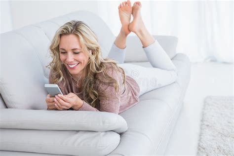 Smiling Blonde Lying On Couch Text Messaging Stock Photo Image Of Blonde Domestic 49267652