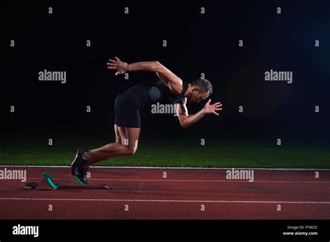 Sprinter Leaving Starting Blocks On The Running Track Explosive Start