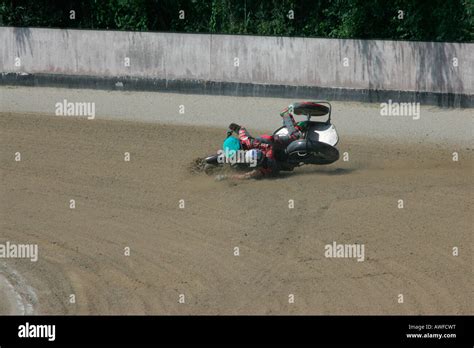 Sidecar motorcycle crash at an international motorcycle race on a dirt track speedway in ...