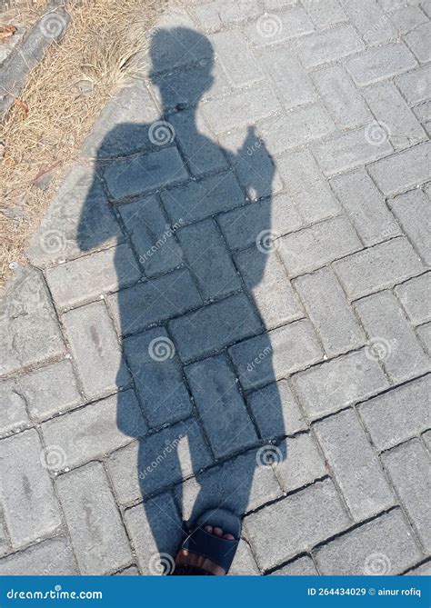 Shadow Of A Man Walking Down The Street Stock Image Image Of Iron