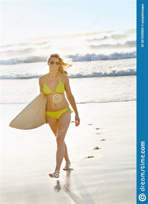 Surfing is Her Life. a Young Surfer Girl on the Beach during the Summer ...