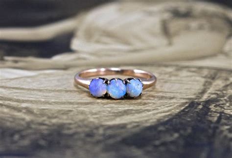 Circa 1900 This Antique Victorian Promise Ring Features Three Opal