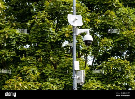 Cctv Camera On Metal Pole In Public Park For Monitor Observe And