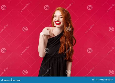 Portrait Of Elegant Coquettish Redhead Woman In Black Dress And Evening