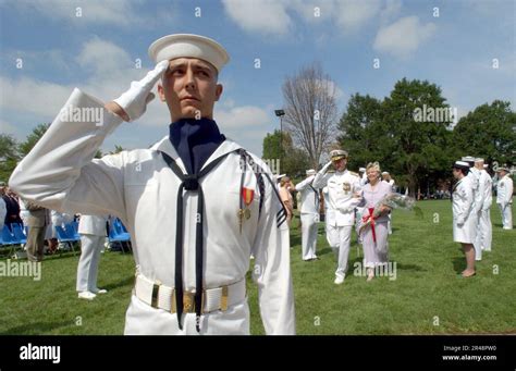 Us Navy A Member Of The Navy S Ceremonial Guard Renders Honors Stock