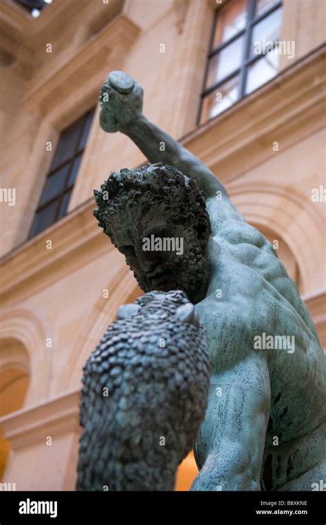 Statue Of Hercules Fighting A Snake At The Louvre Museum Stock Photo