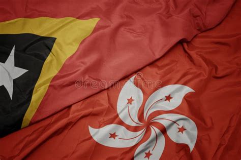 Waving Colorful Flag Of Hong Kong And National Flag Of East Timor Stock