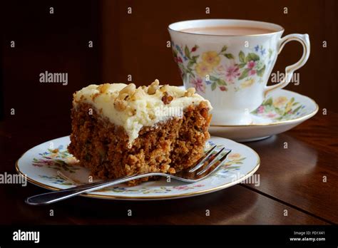 Tea Cup And Saucer With Slice Of Carrot Cake On Matching China Plate