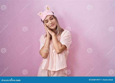 Blonde Caucasian Woman Wearing Sleep Mask And Pajama Sleeping Tired