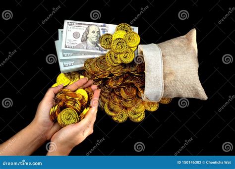 Hand Holding Gold Coin In Treasure Sack And Stack Bundles Of 100 Us Dollars Banknotes Stock