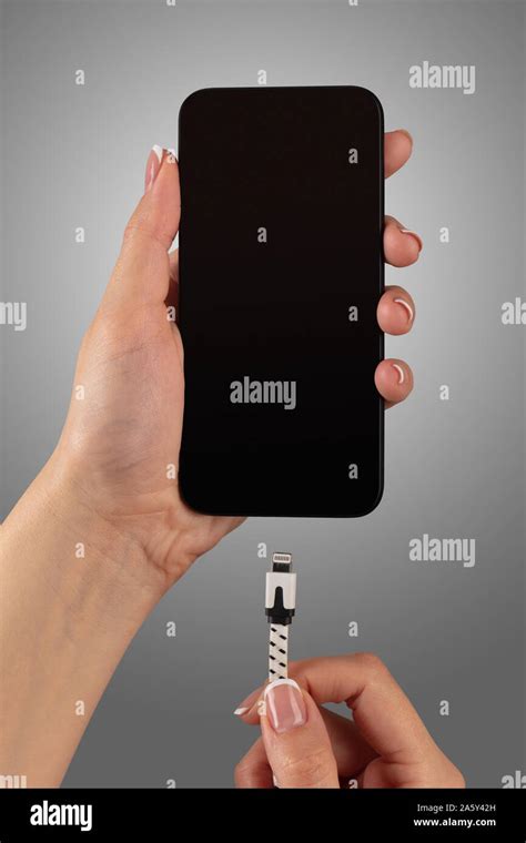 Close Up View Of Hand Charging Smartphone Stock Photo Alamy