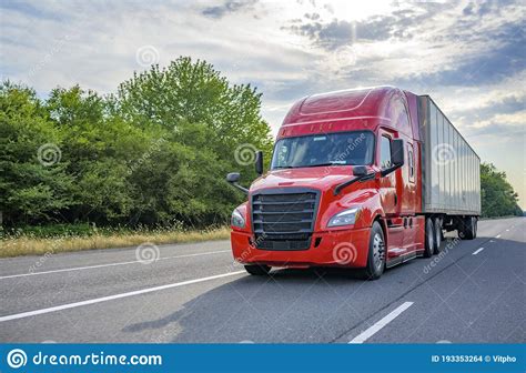 Red Big Rig Long Haul Semi Truck With Black Grille Transporting Cargo