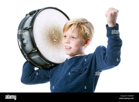 Young Blond Boy With Drum Against White Background In Studio Shows