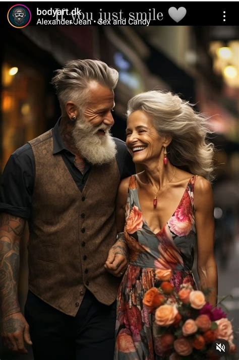 An Older Man And Woman Walking Down The Street With Flowers In Their