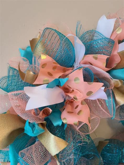 A Close Up Of A Wreath Made Out Of Mesh And Fabric Ribbons With Polka