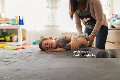 Mother Changing Her Sons Diaper High Res Stock Photo Getty Images