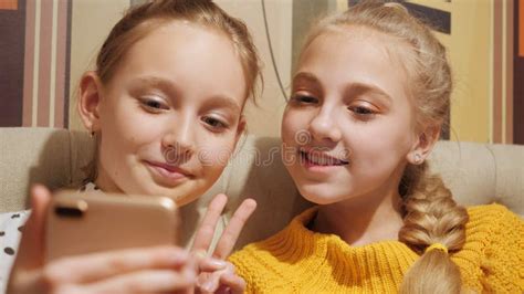 Two Teenager Girl Showing Victory Sign For Mobile Selfie Teenager