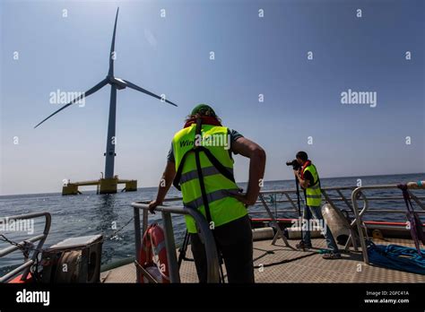 Cameramen Are Seen Taking Images Of The Wind Turbines Off The Coast Of