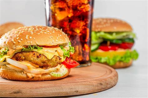 Burger With Cutlet Cheese And Vegetables With A Glass Of Coca Cola