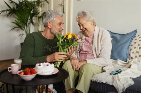 Mature Man Visiting His Senior Mother At Her Apartment Stock Photo Image Of Grandmother