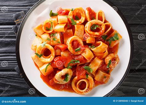 Italian Calamarata Pasta With Calamari And Tomato Sauce Close Up In A