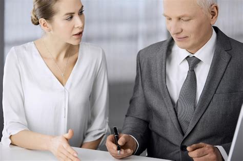 Premium Photo Elderly Businessman And Woman Sitting And Communicating