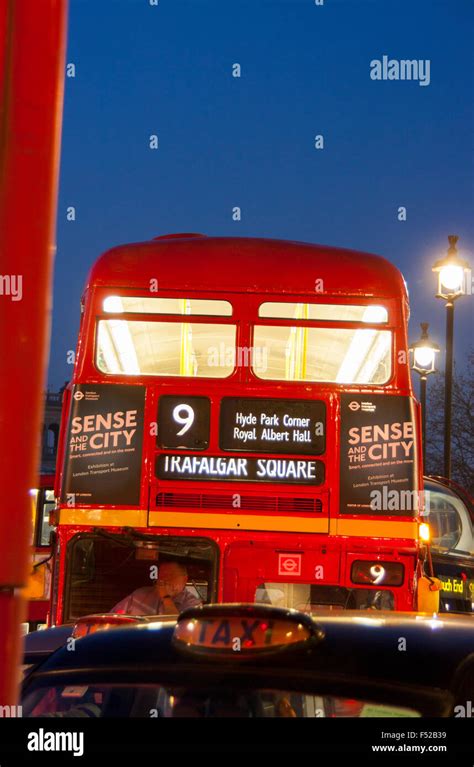 Traditional London Routemaster Bus Number 9 And Black Taxi Cab In