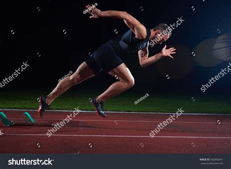 Sprinter Leaving Starting Blocks On The Running Track Explosive Start