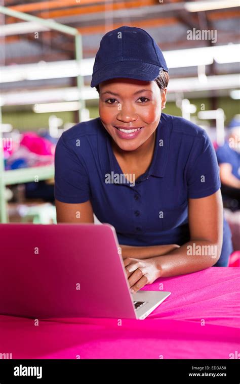 Pretty African Clothing Factory Designer Using Laptop Computer Stock