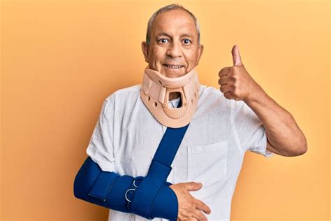 Handsome Mature Senior Man Wearing Cervical Collar And Arm On Sling