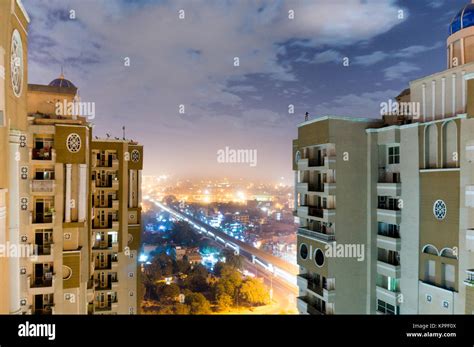 Skyscrapers shot on a cloudy night with the noida delhi cityscape ...