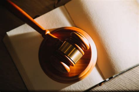 Premium Photo Law Books And Scales Of Justice On Desk In Library Of