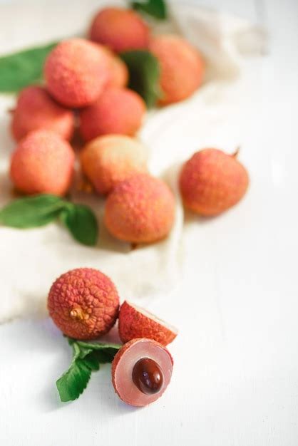 Premium Photo Fresh Ripe Lychee Fruit And Peeled Lychee With Green