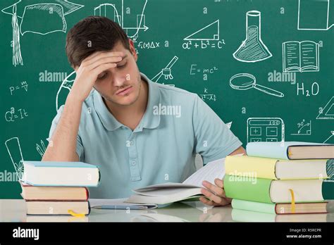 Man Reading Book In Library Stock Photo - Alamy