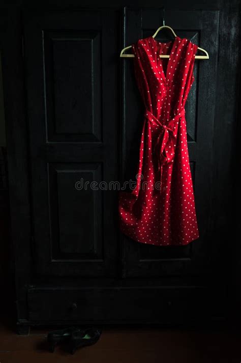 Red Dress in a White Dots on a Wooden Hanger on a Black Vintage ...