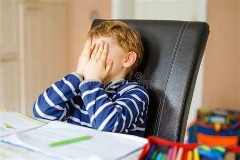 Portrait Of Frustrated Crying Sad School Kid Boy At Home Making